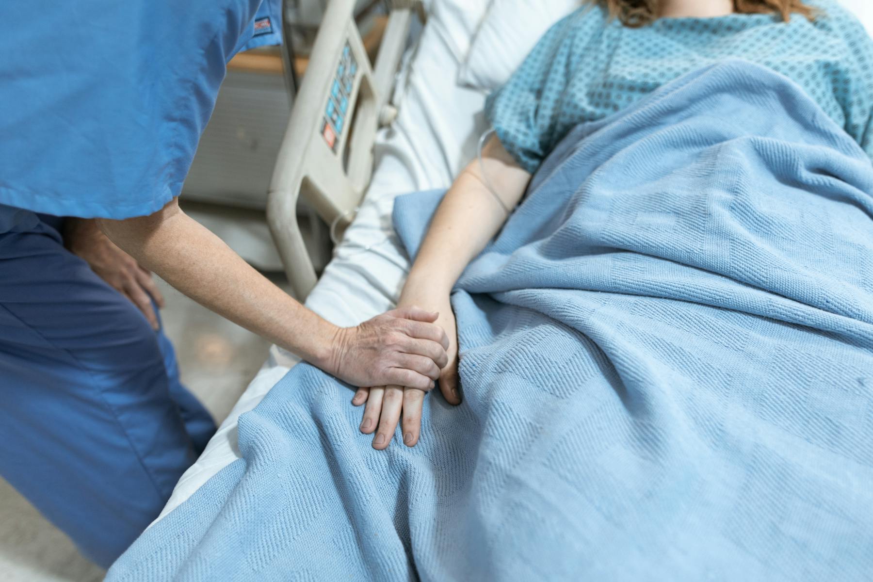 A nurse comforting a patient