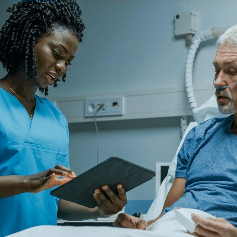 A nurse reviewing care with a patient